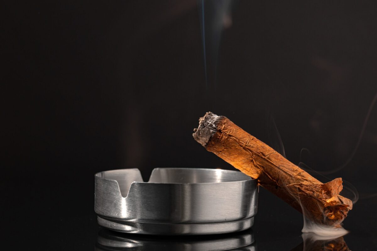 burning-cigar-against-black-background-close-up-2021-09-03-12-44-27-utc-scaled